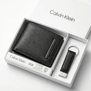 Top-down studio product photography of the Calvin Klein mirror original smooth black leather wallet and keychain set neatly resting inside its open white branded gift box