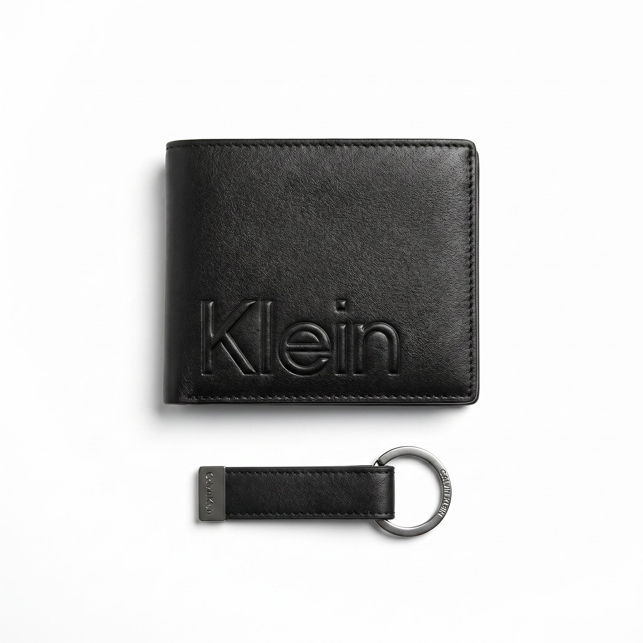 Professional angled studio photograph of the Calvin Klein mirror original smooth black leather wallet back panel showing the debossed Klein text logo