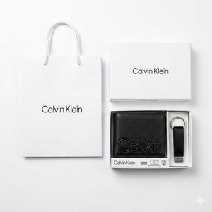 Full premium packaging presentation of the Calvin Klein mirror original smooth black leather bifold wallet and keychain set with its white gift box and matching shopping bag