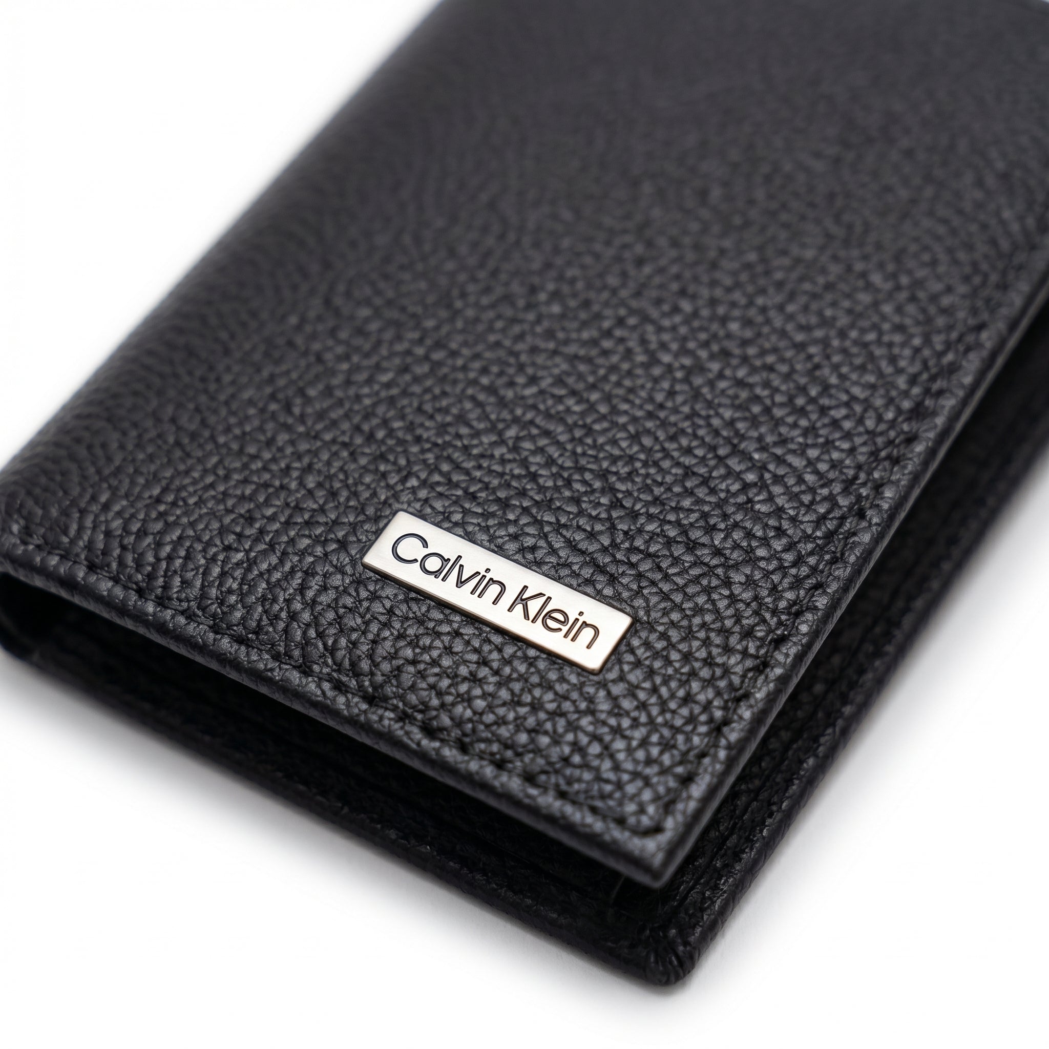 Front view of the Calvin Klein black genuine leather wallet showing the classic silver metal logo and premium stitching