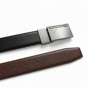 Detailed view of the Calvin Klein double-face leather belt showing the reversible black and brown premium leather sides