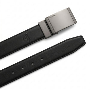 Detailed close-up of the Calvin Klein matte black plaque buckle showing the precision engraved brand logo