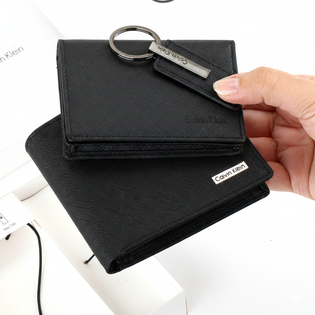 Handheld view of the Calvin Klein men's accessory gift set, including a black saffiano leather wallet, a slim card holder, and a silver-accented keychain