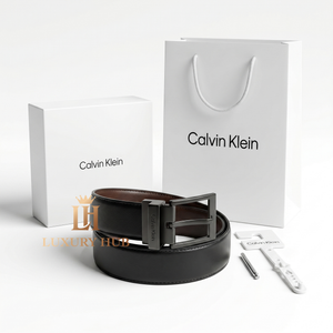 Top view product photography of Calvin Klein reversible leather belt presented with its signature white gift box