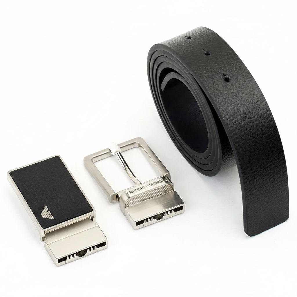 Perspective view of an Emporio Armani men's black textured leather belt set with its two stylish interchangeable metal buckles on a clean white background
