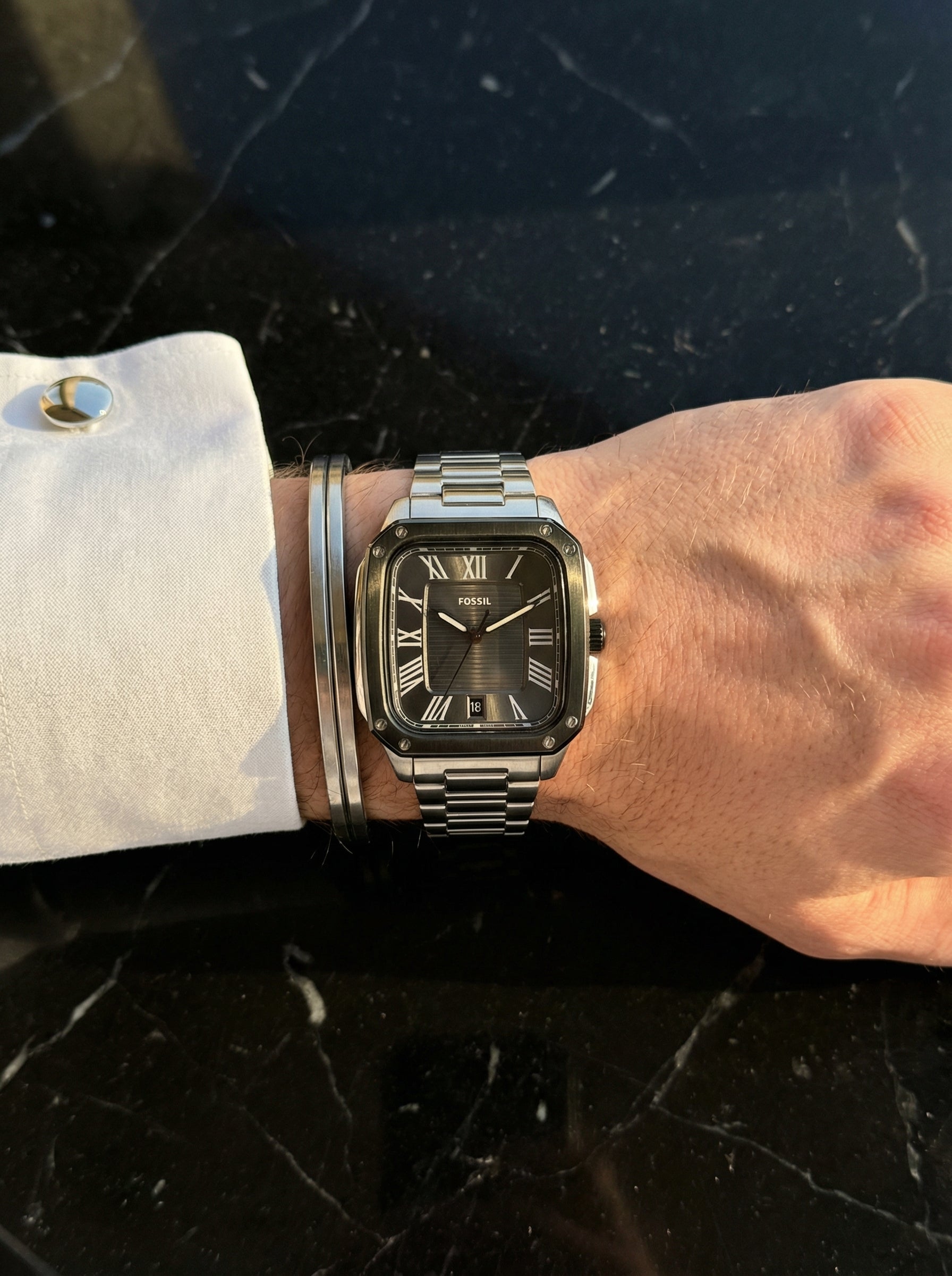 Close up shot of Fossil FS6122 on wrist showing square black dial and roman numerals