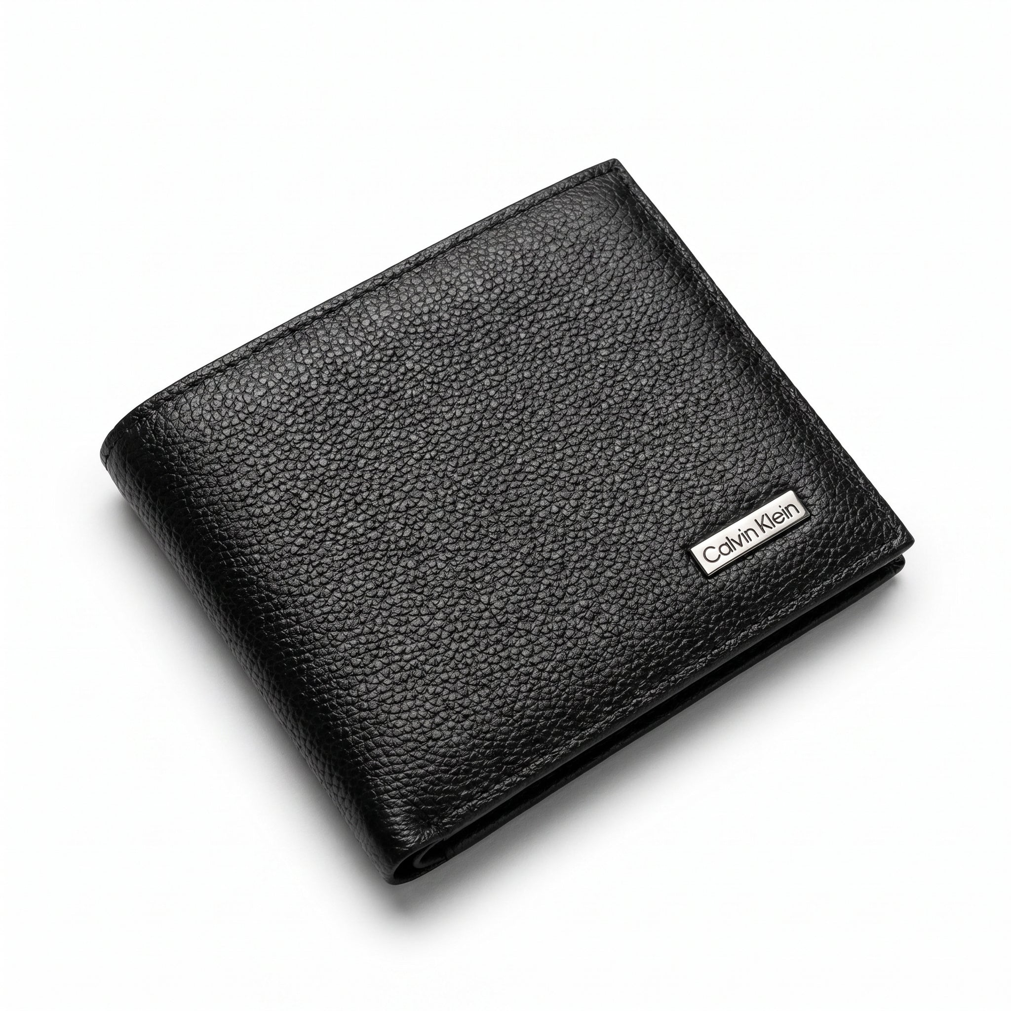 Professional angled studio photograph of the sleek Calvin Klein mirror original pebbled black leather bi-fold wallet