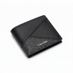 Professional angled studio photograph of the sleek Calvin Klein mirror original smooth black leather bifold wallet