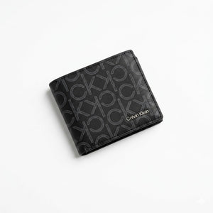 Professional angled studio photograph of the sleek Calvin Klein mirror original black leather bi-fold wallet covered in grey ck monogram