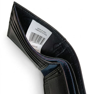 Inside view of the Calvin Klein trifold wallet currency pocket showing the white authenticity label, barcode tag, and inner lining