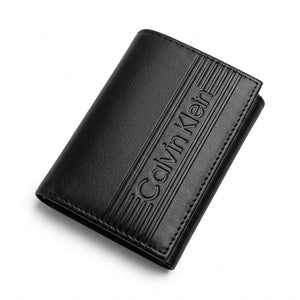 Professional angled studio photograph of the sleek Calvin Klein mirror original smooth black leather trifold wallet