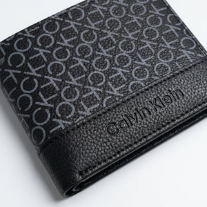 Professional angled studio photograph of the sleek Calvin Klein mirror original smooth black leather trifold wallet