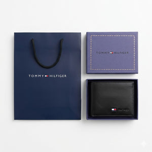 Full premium presentation of the Tommy Hilfiger mirror original smooth black leather wallet set with its navy gift box and matching shopping bag