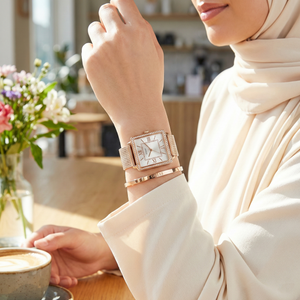 Female model wearing Guess Chelsea W0826L3 rose gold watch with a sophisticated office outfit