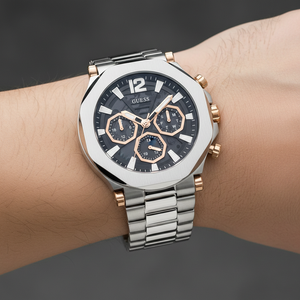 Close up shot of Guess Edge GW0539G1 watch on wrist showing the black industrial dial and rose gold sub-dials
