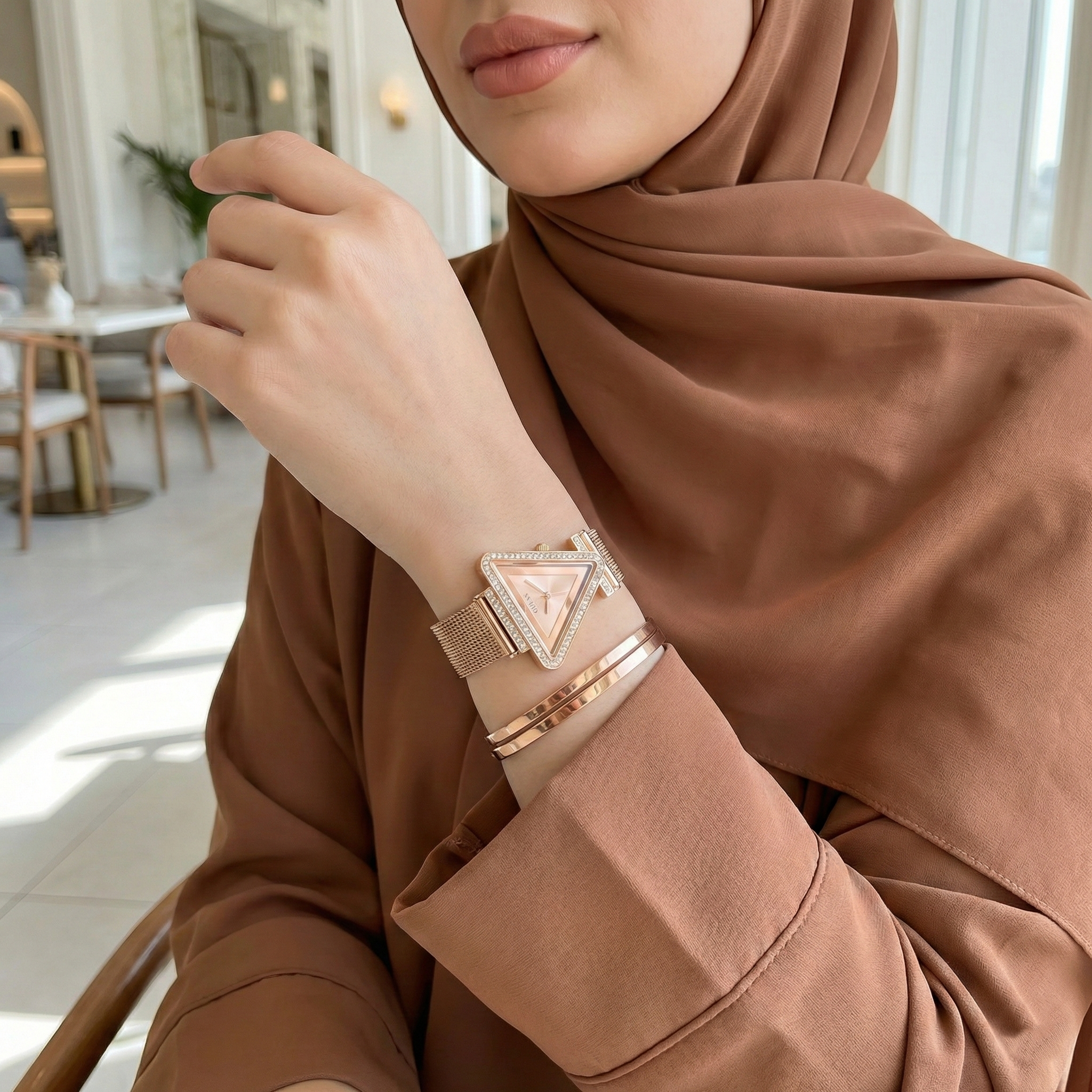 Woman wearing Guess Fame GW0508L3 rose gold triangle watch with a trendy outfit