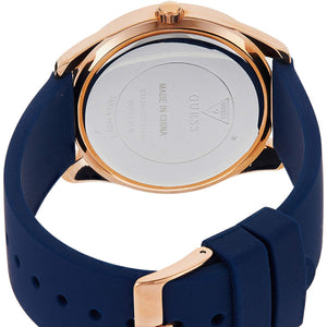 Rose gold tone stainless steel buckle clasp with Guess logo on the blue silicone strap of the W0911L6