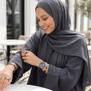 Female model wearing Guess G Twist W1201L4 gunmetal watch with an elegant evening outfit