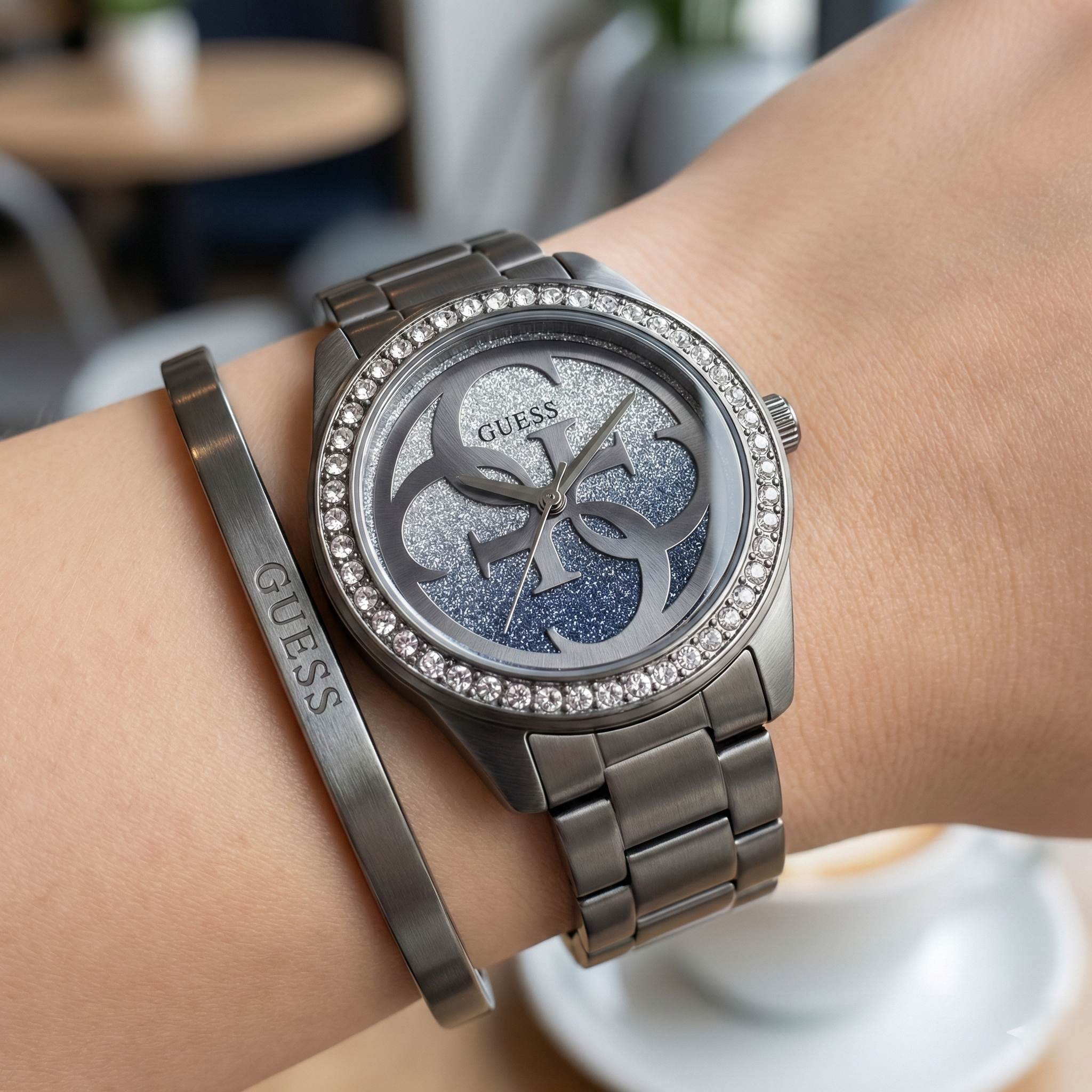 Close up shot of Guess G Twist W1201L4 watch on wrist showing the sparkling crystal bezel and 4G logo