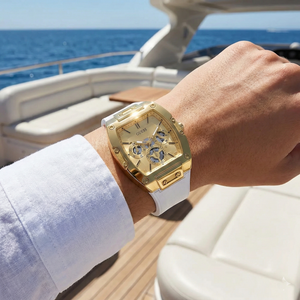 AI lifestyle shot of a man wearing the gold and white Guess Phoenix watch