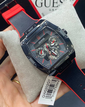 Authentic real-life photo of the Guess GW0202G7 showing actual black rubber texture and red accents in Egypt