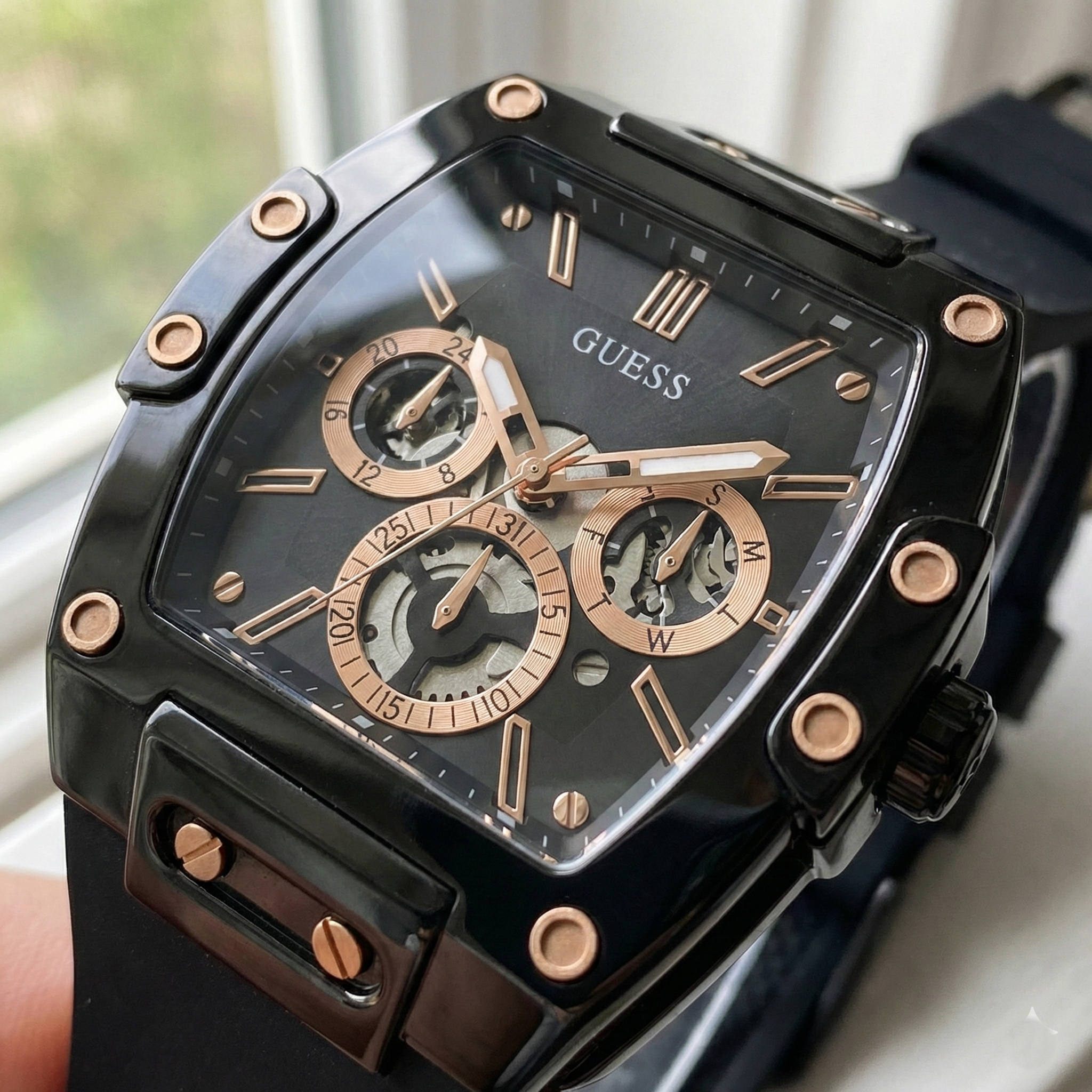 Close up shot of Guess GW0203G8 on wrist highlighting the black skeleton dial and rose gold hands