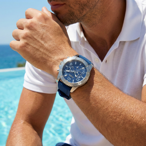 Male model wearing Guess GW0211G1 silver and blue rubber watch with a casual outfit