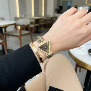 AI lifestyle shot of a woman wearing Guess GW0504L3 leopard print watch