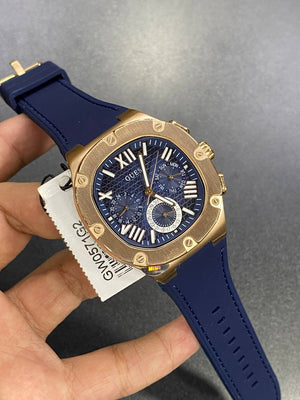 Authentic real-life photo of the Guess GW0571G2 watch showing actual rose gold shine and navy dial texture
