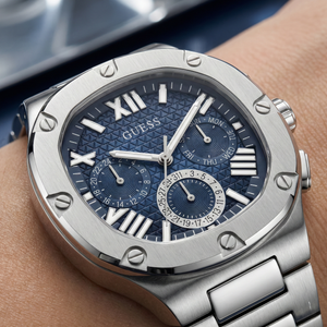 Detailed close-up of the blue textured multifunction dial with Roman numerals on Guess GW0572G1