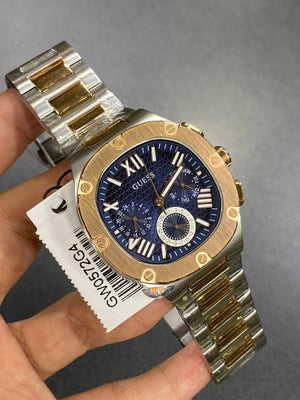 Authentic real-life photo of the Guess GW0572G4 watch showing actual two-tone shine and blue dial depth