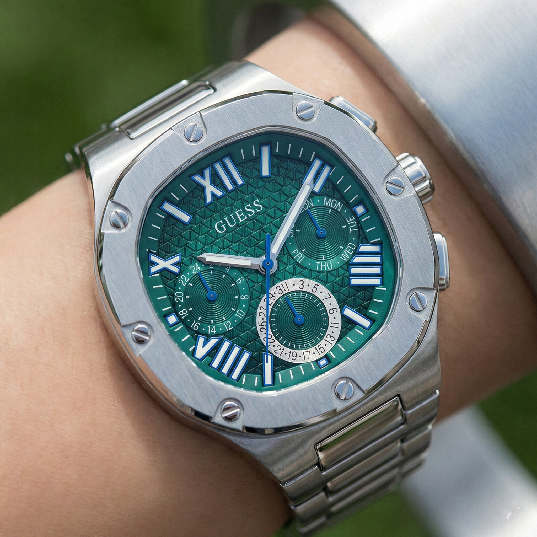 Detailed close-up of the green textured multifunction dial with Roman numerals on Guess GW0572G6