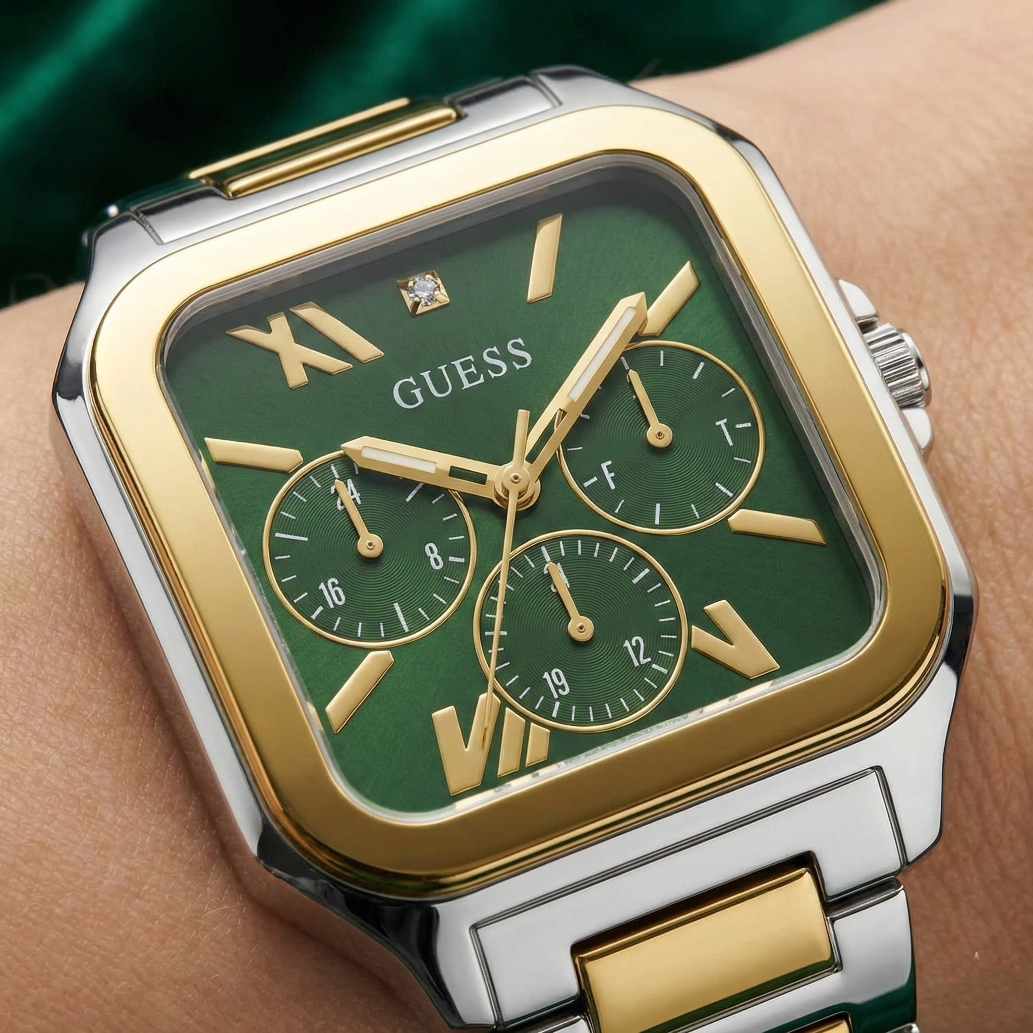 Close-up of the green multifunction dial and diamond marker on Guess GW0631G1