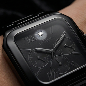 Close up shot of Guess GW0631G2 watch on wrist showing the black square dial and tonal sub-dials
