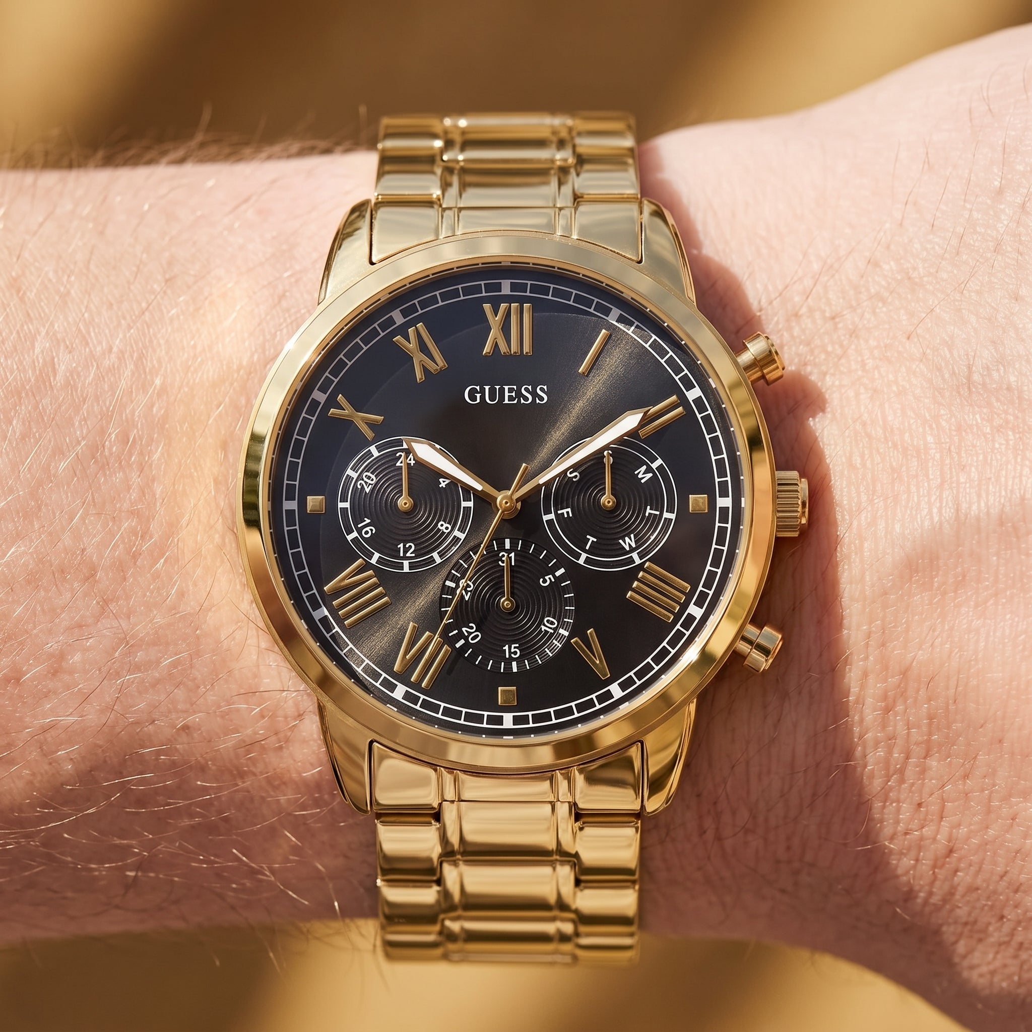 Wrist shot of Guess Hendrix W1309G2 watch showing the gold metal band