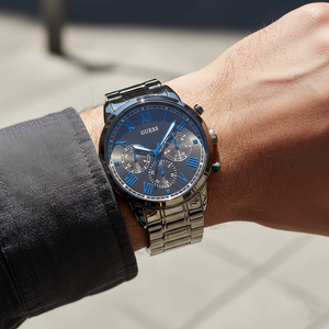 Close up shot of Guess Hendrix W1309G3 watch on wrist showing the minimalist grey dial