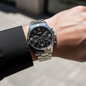 Man wearing Guess Horizon W0379G1 silver metal watch with a classic shirt and tie