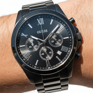 Close up shot of Guess Horizon W0379G2 watch on wrist showing the black dial and silver roman numerals