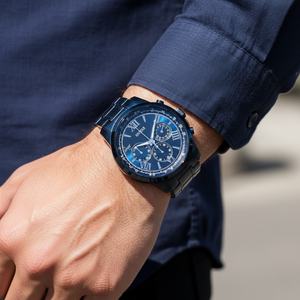 Man wearing Guess Horizon W0379G5 blue metal watch with a formal business suit