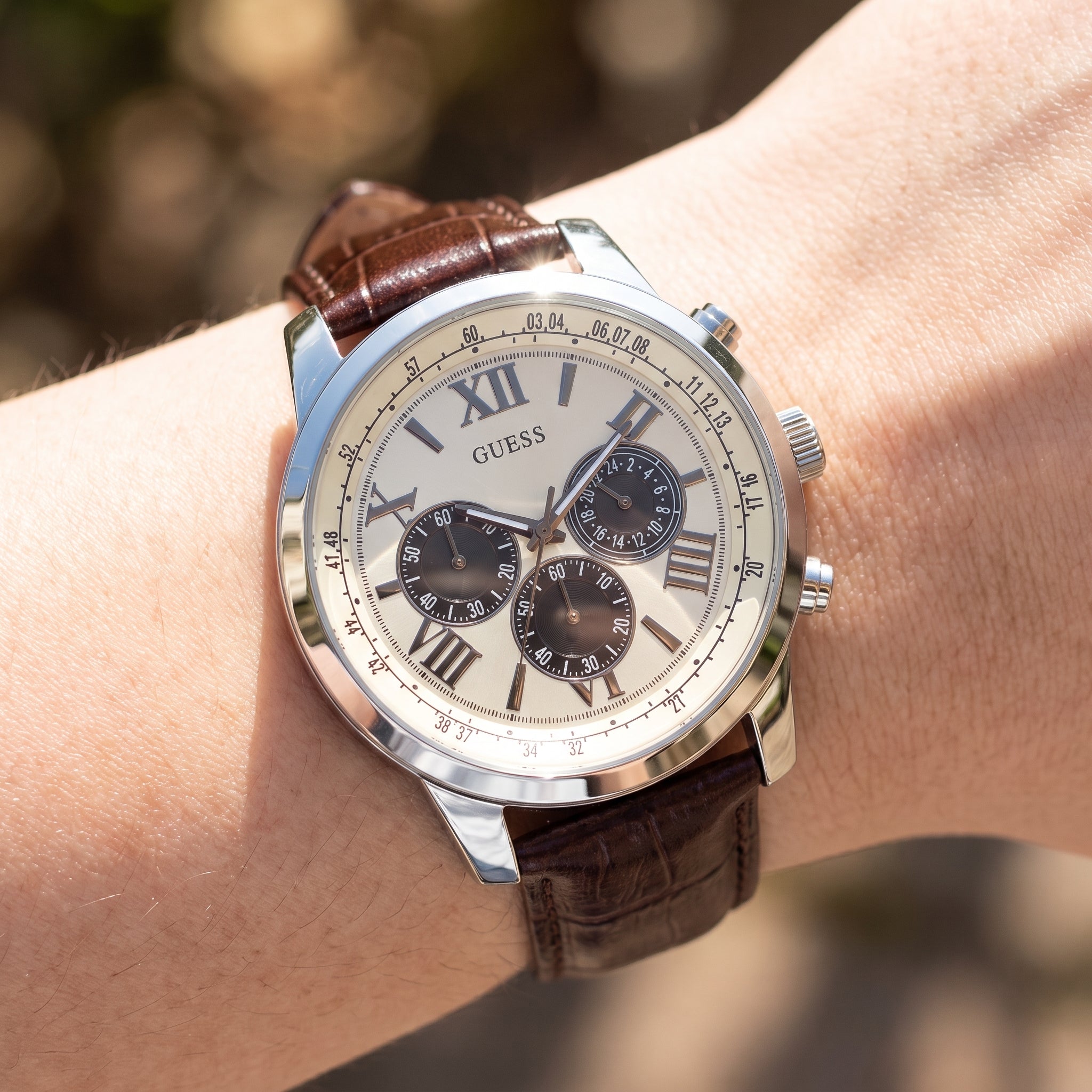 Wrist shot of Guess Horizon W0380G1 watch showing the brown leather band