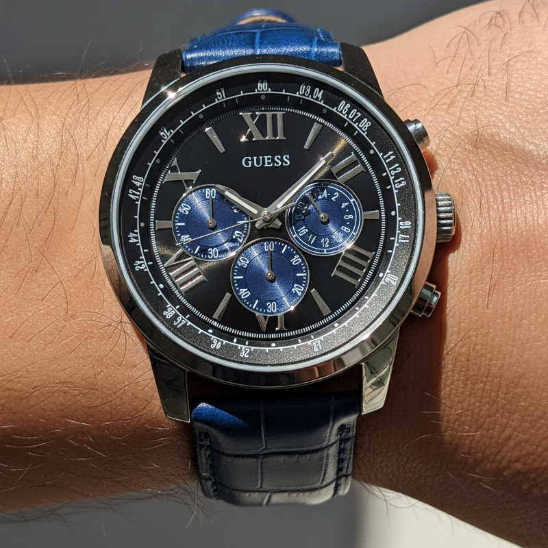 Close up shot of Guess Horizon W0380G3 watch on wrist showing the blue sub-dials and roman numerals