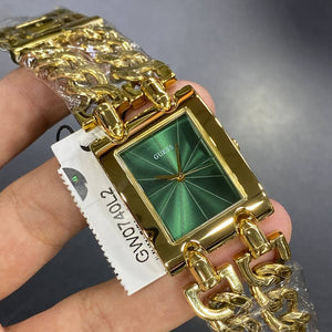 Authentic real-life photo of the Guess Mod Heavy Metal GW0740L2 watch showing actual gold chain and green dial