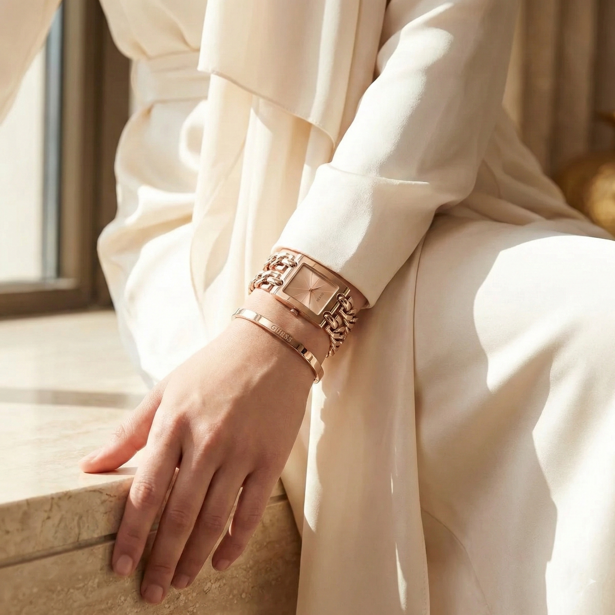 Woman wearing Guess Mod Heavy Metal W1117L3 rose gold watch with an elegant dress