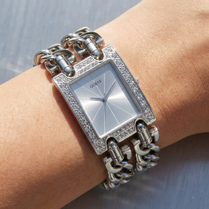 Close up shot of Guess W1121L1 watch on wrist showing the sparkling crystal bezel and silver chain links