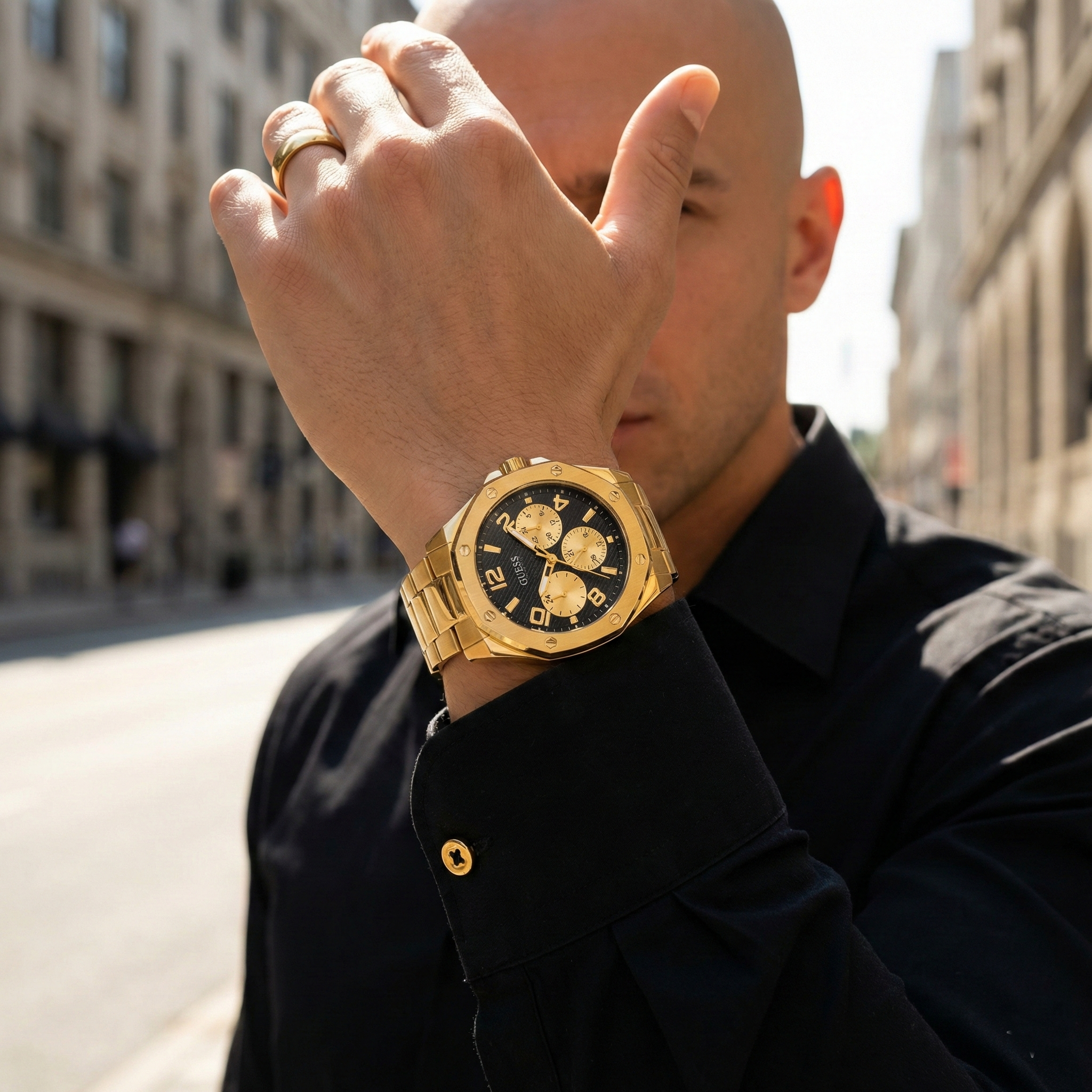 Man wearing Guess Momentum gw0489g2 gold steel watch with a formal suit