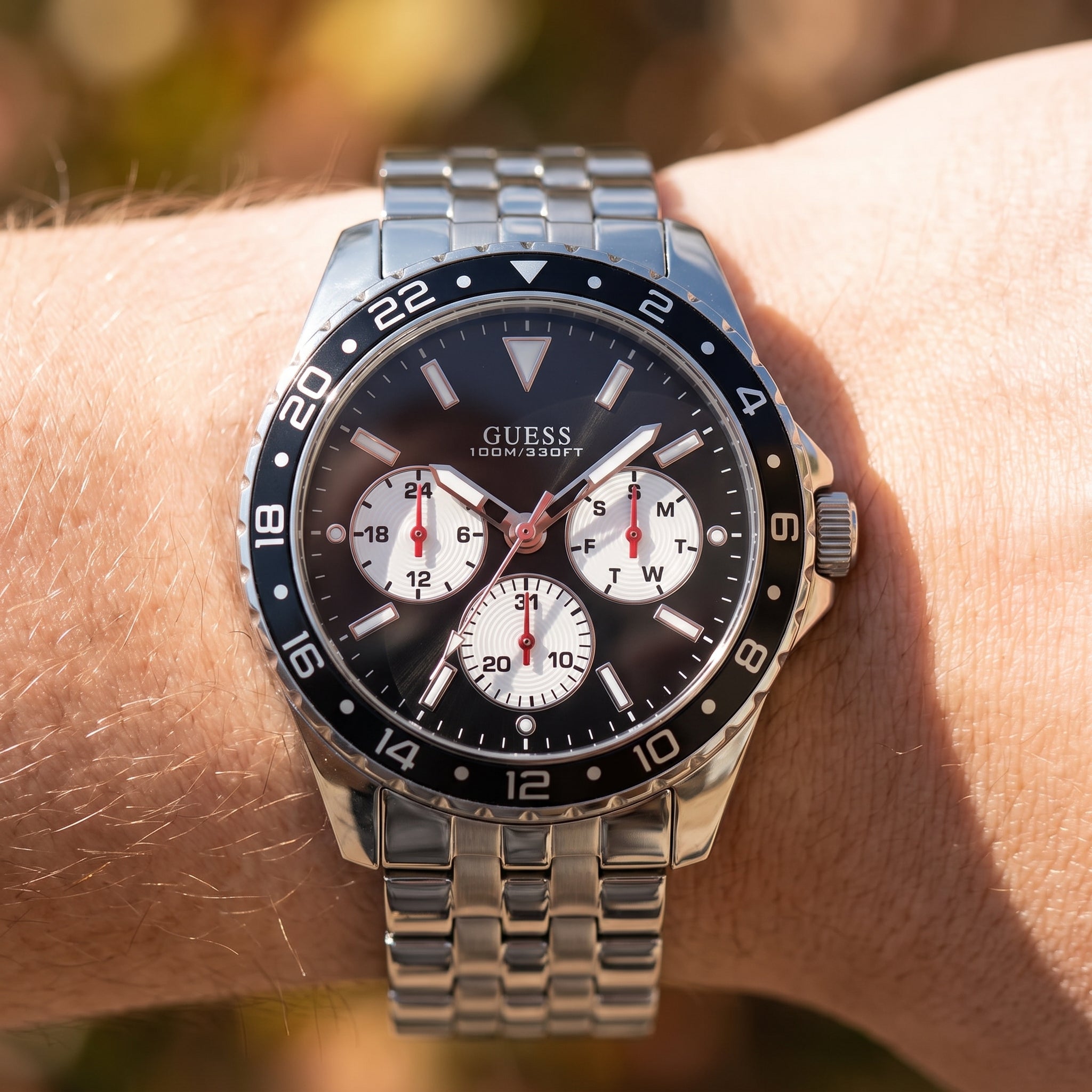 Wrist shot of Guess Odyssey W1107G1 watch showing the silver metal band