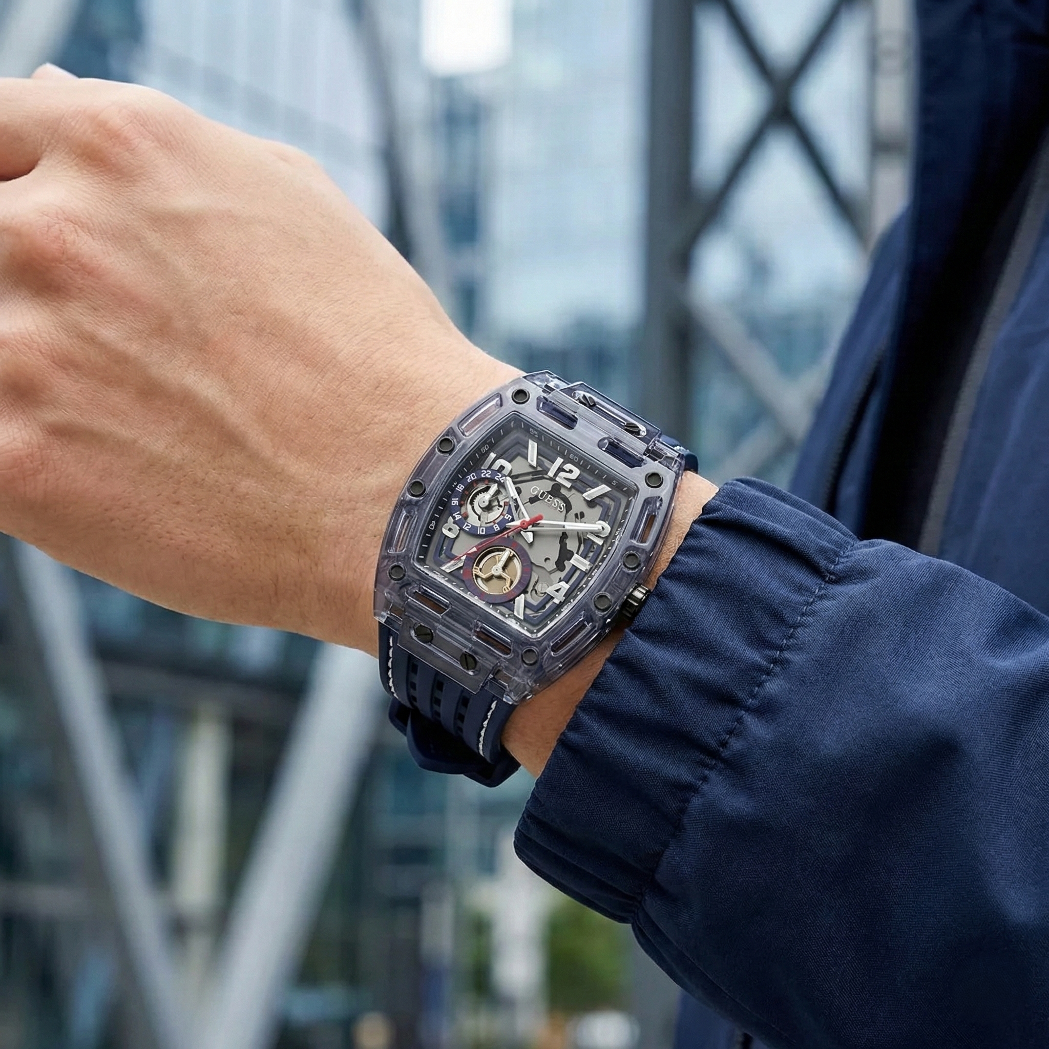 Close up shot of Guess Phoenix GW0499G1 watch on wrist showing the blue multifunction dial and industrial screws