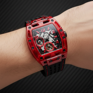 Close up shot of Guess Phoenix GW0499G4 watch on wrist showing the black skeleton dial and red screw details