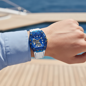 Male model wearing Guess Phoenix GW0499G6 blue transparent watch with a casual white outfit