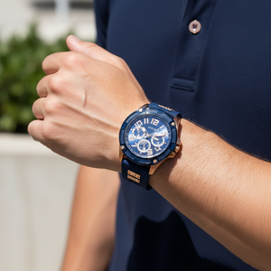 Man wearing Guess Rig GW0051G3 rose gold and blue watch with a sporty outfit